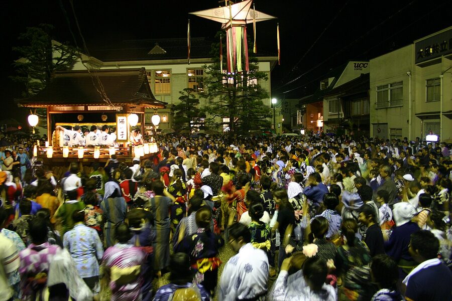 Gujo Odori dancers under cut-paper lanterns in front of the Kyu-Chosha Kinenkan