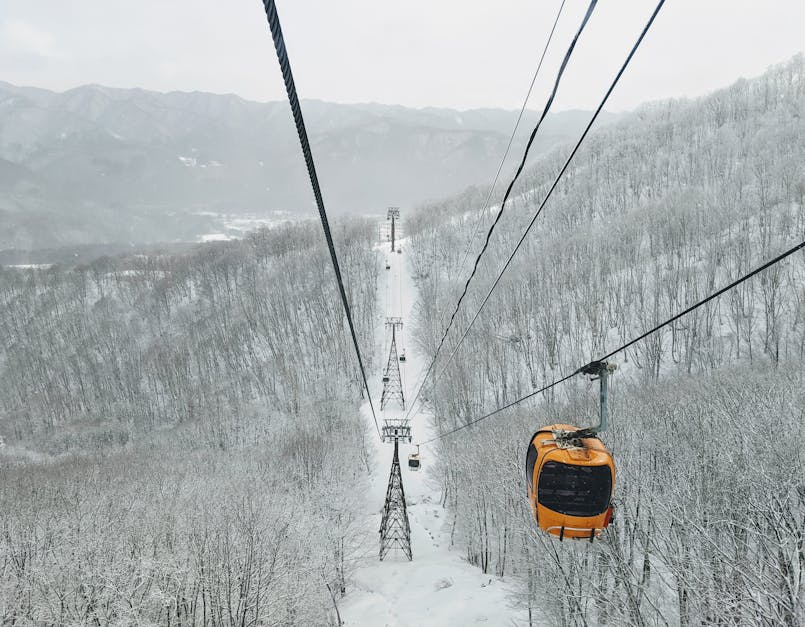 Cable car journey over snow-covered forests in Hakuba, Nagano