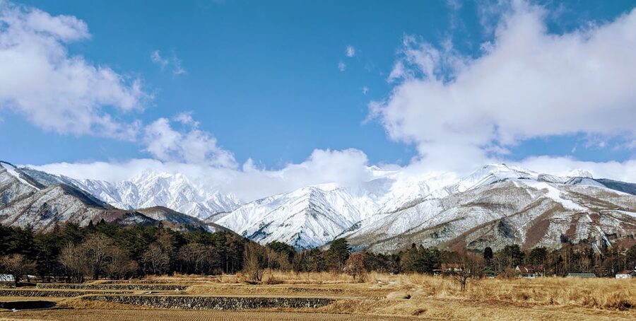 Snow-capped mountains in Hakuba under blue sky