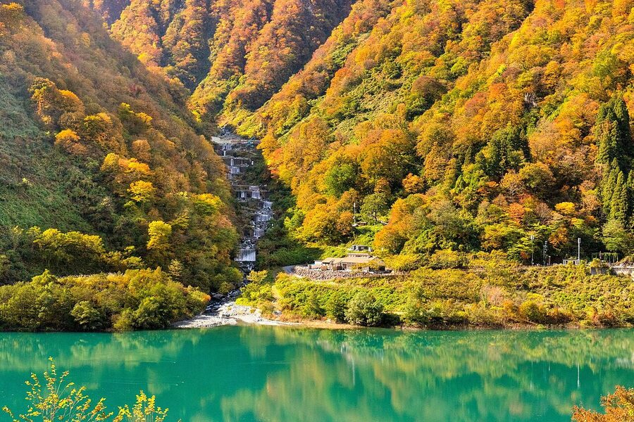 Toroko train running through autumn-coloured Kurobe Gorge