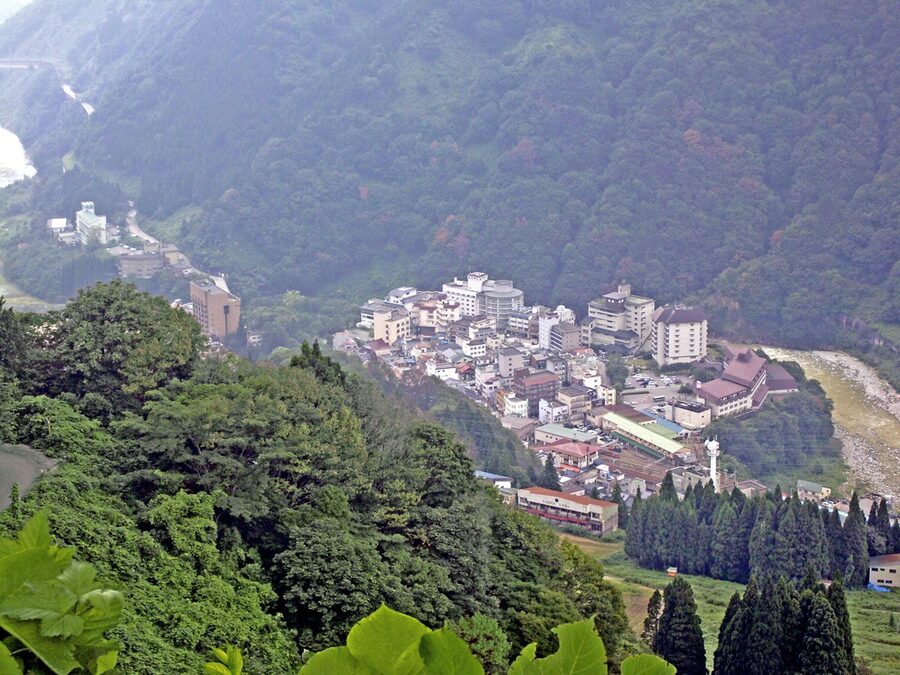Unazuki Onsen town from above with hotels along the gorge