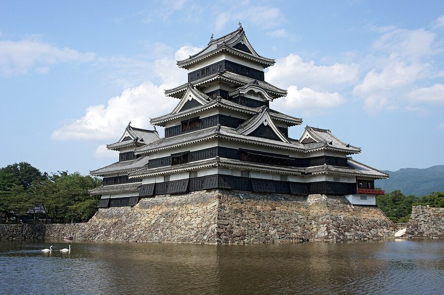 Matsumoto Castle reflected in its moat at sunrise