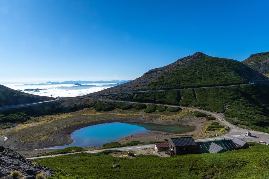 Calm pond reflecting Norikura volcano on the plateau
