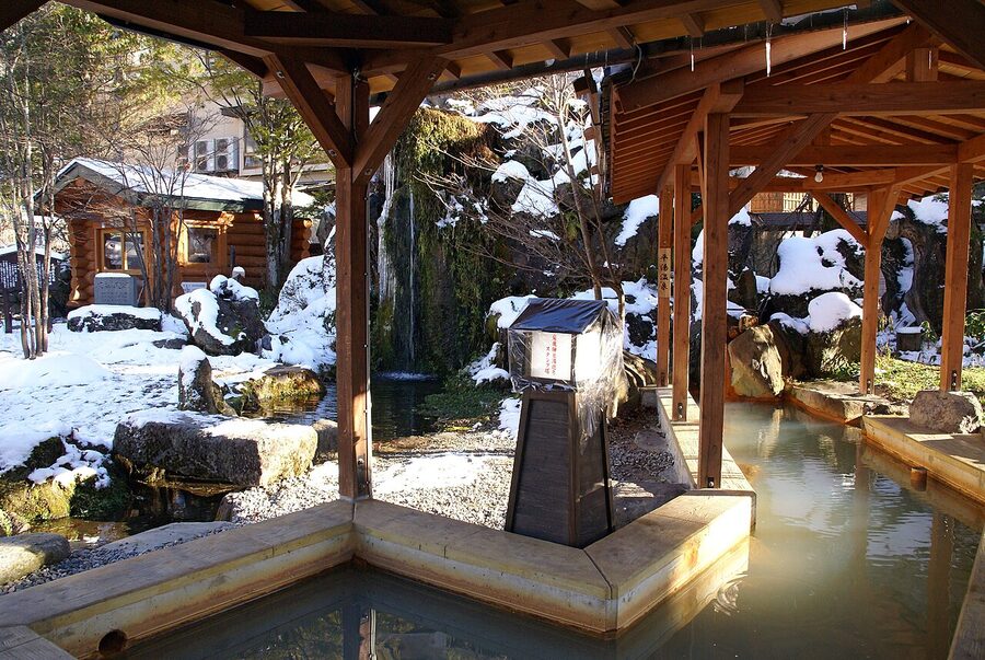 A Hirayu Onsen bathhouse exterior with snow