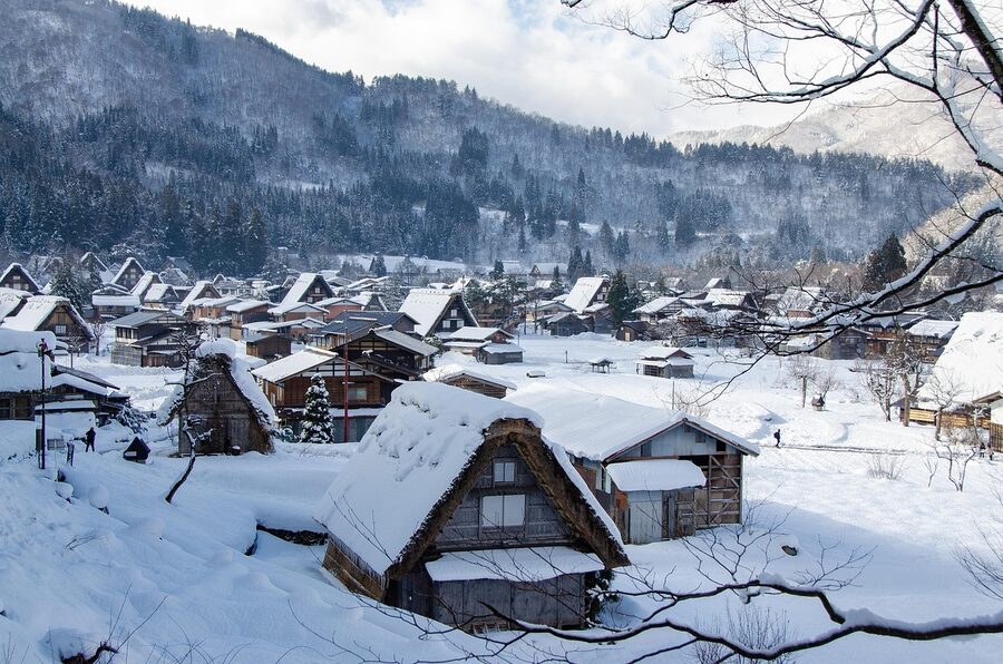 Steam rising over an onsen village in winter