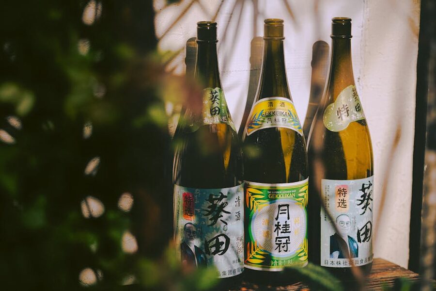 Three Japanese sake bottles with distinctive labels
