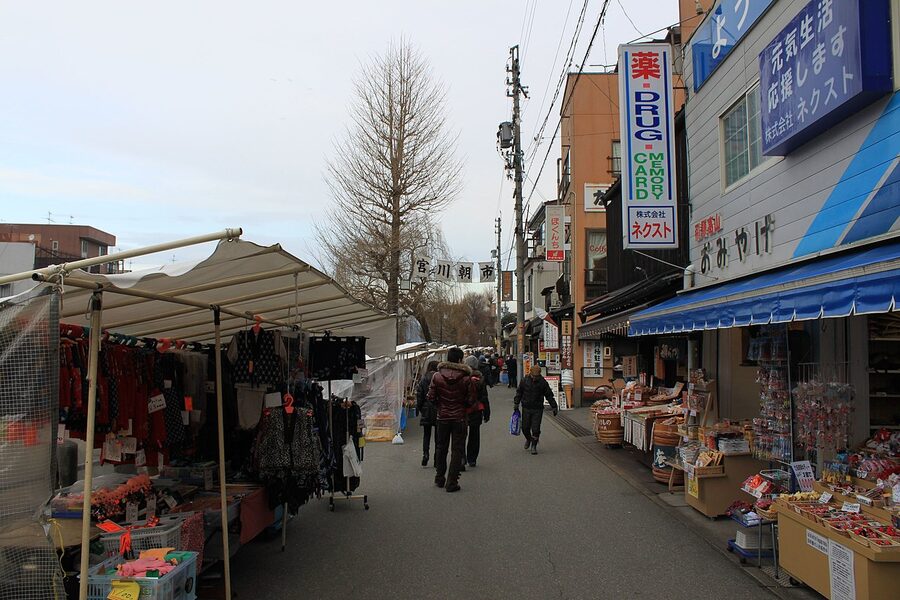 Miyagawa morning market scene with stalls and shoppers