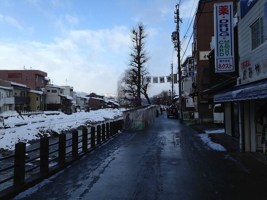 White-tent stalls of Miyagawa Morning Market along the river in Takayama
