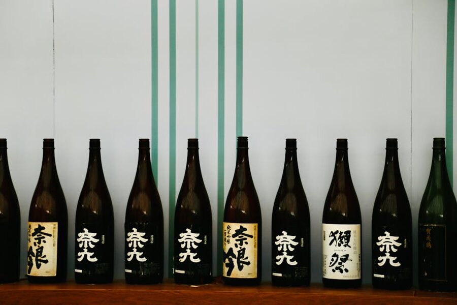 Bottles of Japanese sake on a wooden shelf