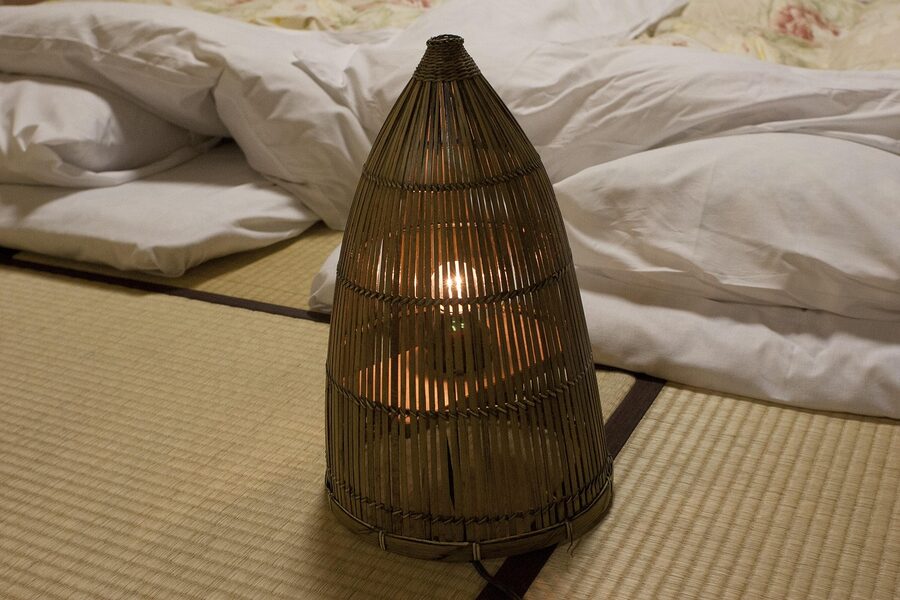 Traditional Japanese ryokan tatami room with futon and lantern