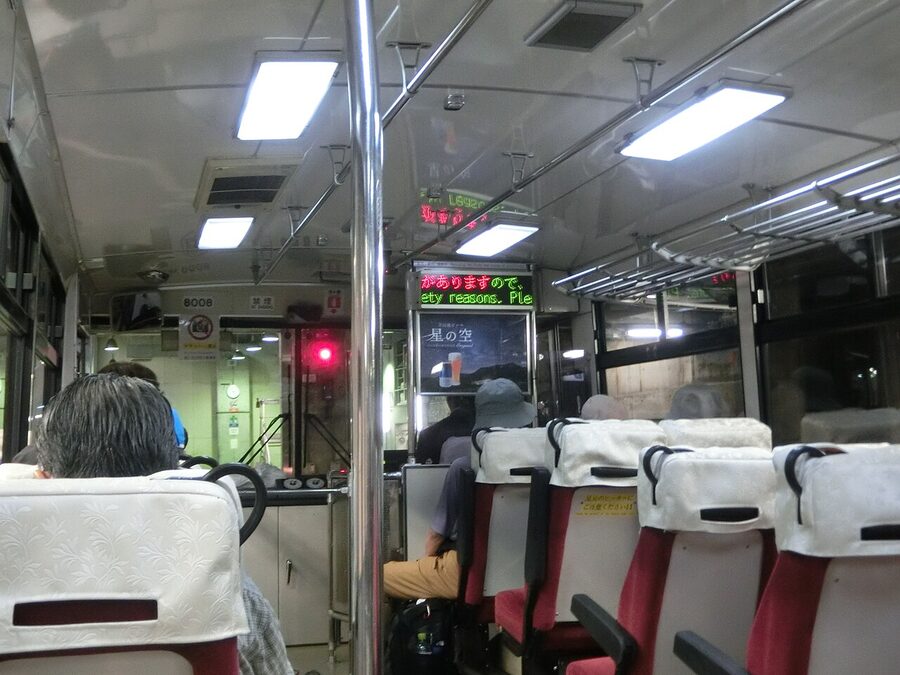 Inside the old Tateyama Tunnel Trolleybus showing seats and overhead handles