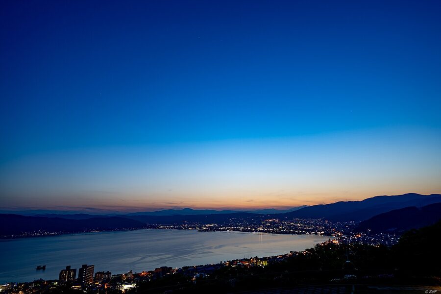Lake Suwa in May with mountains in the distance