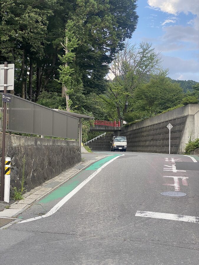 A road leading into Suwa with mountains in the background
