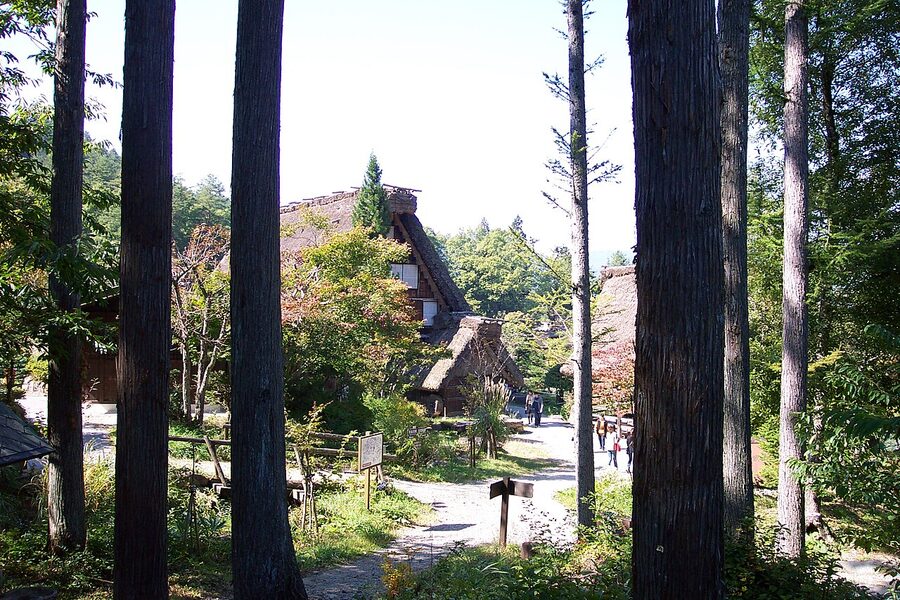 Gassho-zukuri farmhouse exterior with steep thatched roof at Hida Folk Village